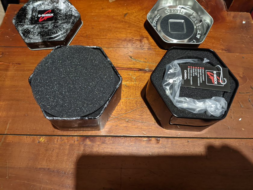 The open containers with the watch inside